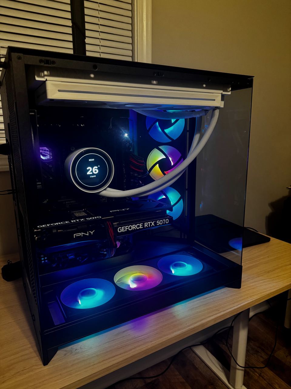 Jacob’s custom PC build with its RGB lighting on: a glass-sided black case with a white liquid cooler and a GeForce RTX 5070 graphics card.
